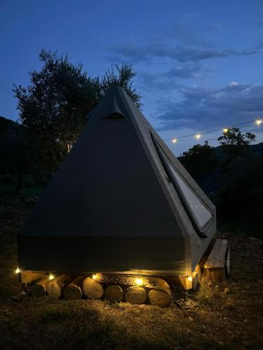 a tent with lights in a field at night at Tipì in Chiusanico