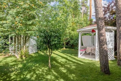 a garden with a gazebo and a tree at Seasons SPA Boutique Hotel in Kozin
