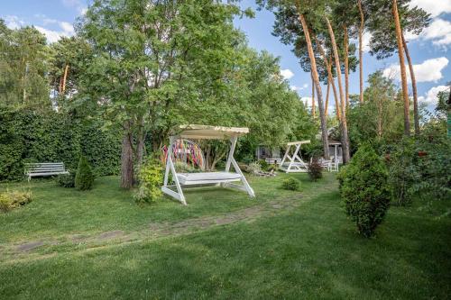 a backyard with a swing set in the grass at Seasons SPA Boutique Hotel in Kozin