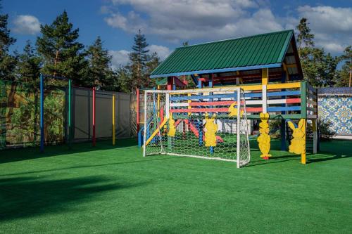 a playground with a goal in the grass at Seasons SPA Boutique Hotel in Kozin