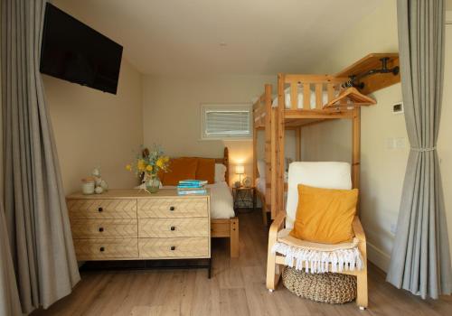 a bedroom with a bunk bed and a dresser at Luxury Silver Birch Lodge: Hot Tub/BBQ/Fire Pit in Toppesfield