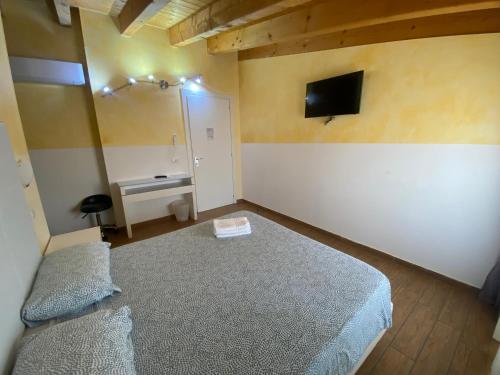 a small bedroom with a bed and a desk at Via Mameli 5 in Sanremo