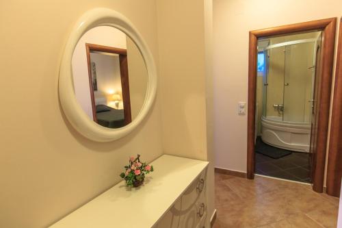 a bathroom with a sink and a mirror at Yu&li Rose Apartments Adriatic in Bar