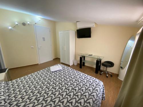a room with a bed and a table in it at Via Mameli 5 in Sanremo