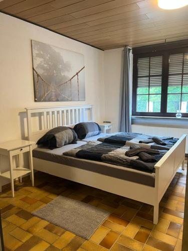 a bedroom with a bed with a bridge painting on the wall at Gemütliche EG-FeWo im Haus zur Vulkaneifel in Brohl in Brohl-Lützing