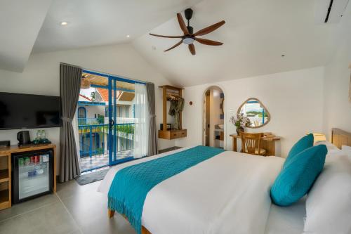 a bedroom with a bed and a large window at The Linh Coastline Villa in Hoi An