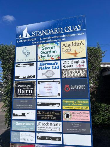 a sign with many different signs on it at Cosy whole home in central Faversham in Kent