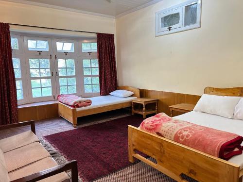 a hotel room with two beds and a window at Ayun Nest Guest House 
