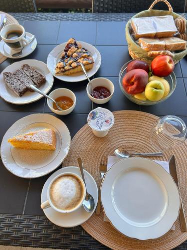 a table with plates of food and cups of coffee at Agriturismo Nonno Ninuccio in Gioi