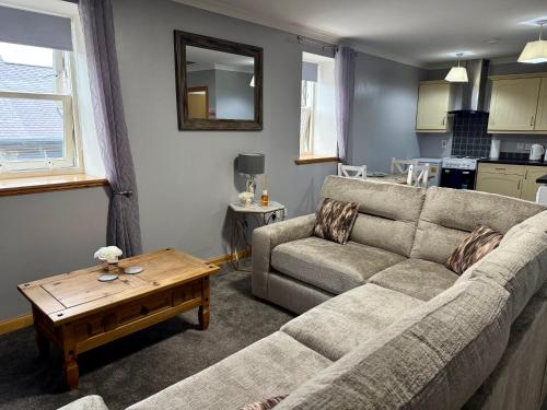a living room with a couch and a table at The Old Salt House, Flat 2 in Wick