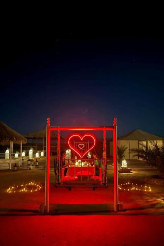 a red heart sign in the middle of a street at Desert Romantic Camp in Merzouga