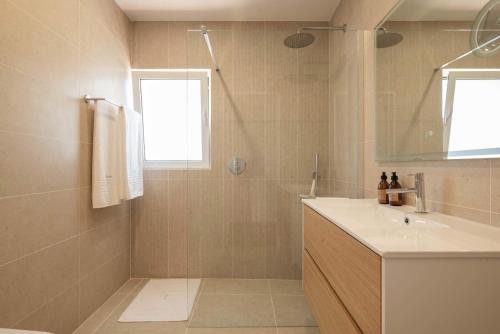 a bathroom with a sink and a shower at Vila Antic in Almancil