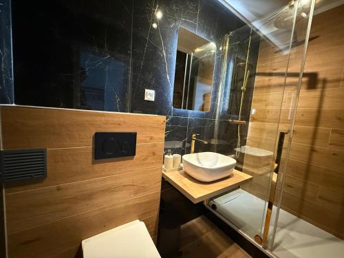 a bathroom with a sink and a glass shower at Penzión Talisman in Rajecké Teplice