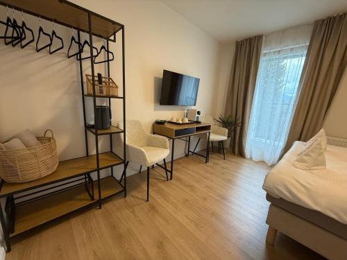 a hotel room with a bedroom with a desk and a bed at Penzión Talisman in Rajecké Teplice