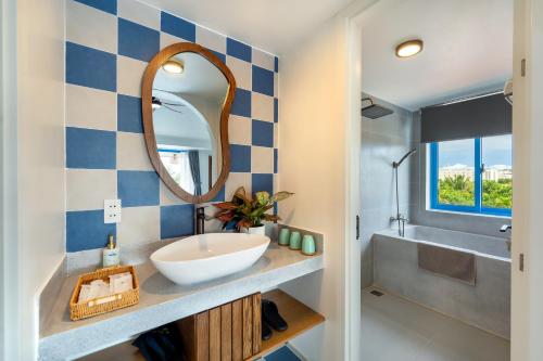 a bathroom with a sink and a mirror at The Linh Coastline Villa in Hoi An