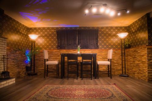 a dining room with a table and chairs in a room at Spacious vintage styled basement apartment - private in Calgary