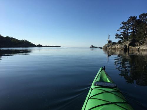 a green kayak on a body of water at Pollyville in Lillesand