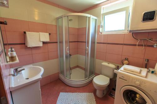 a bathroom with a shower and a toilet and a sink at Yu&li Rose Apartments Adriatic in Bar