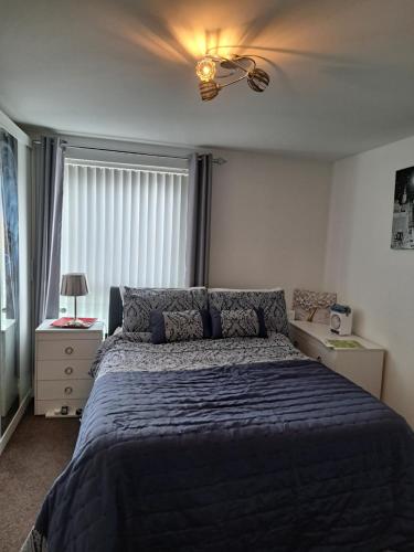 a bedroom with a bed and a ceiling fan at Ebbsfleet International Homestay in Swanscombe