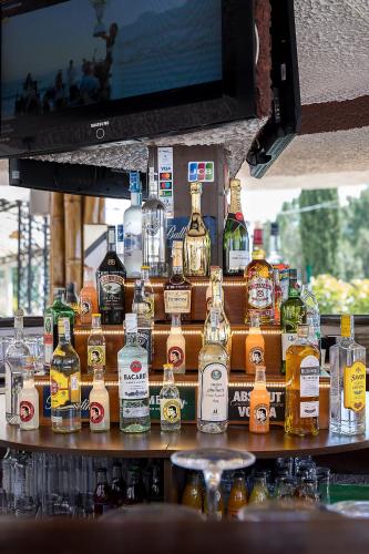 a display of bottles of alcohol on a bar at Bendita Mare Aparthotel in Golden Sands