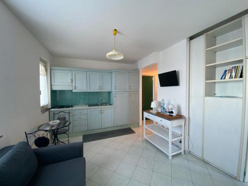 a kitchen with a couch and a table in a room at CannetoMare in Canneto