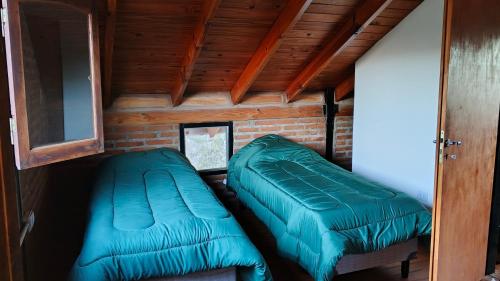 a room with two green beds in a house at Hostel Vida 