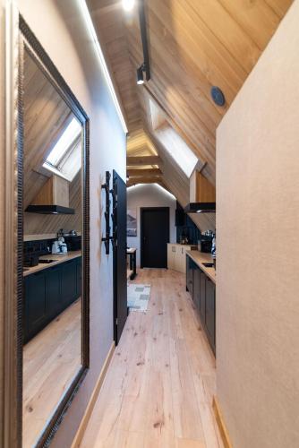 a kitchen with wooden counters and a large mirror at Ośrodek Wypoczynkowy Bernadetta in Murzasichle