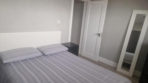 a bedroom with a bed with two pillows on it at Charming City Retreat in Cork in Cork