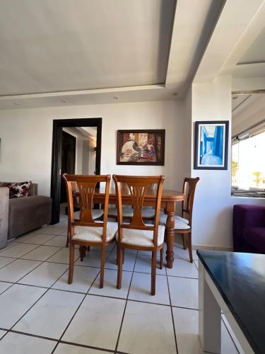 a living room with a table and chairs at Private beach 100 meters, relaxing stay guaranteed in Fnidek