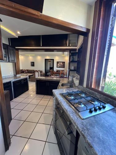 a kitchen with a stove top oven in a room at Private beach 100 meters, relaxing stay guaranteed in Fnidek