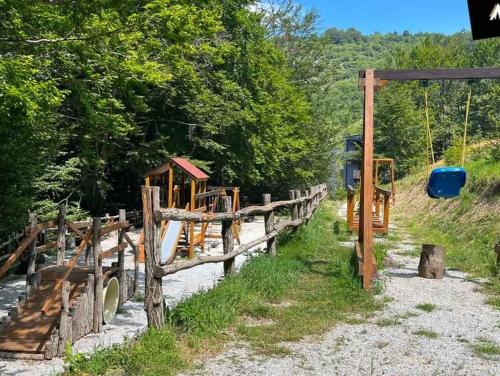 a wooden fence next to a field with trees at Mavrov02 Residence in Mavrovo