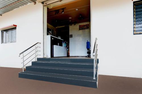 a building with stairs leading to a door with a refrigerator at Hotel O Yuvraj Dhage Plot Shivshakti Maidan in Bārsi