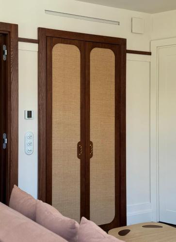a bedroom with a pair of doors on the wall at Hotel de Silhouette in Biarritz