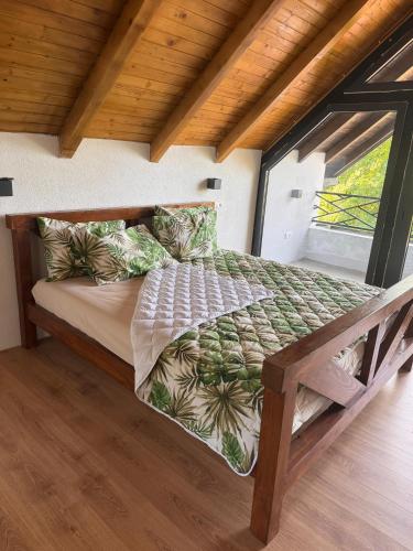 a bed in a room with a large window at Vikendica Radoš 