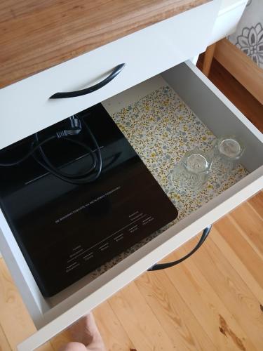 a drawer in a white table with two glasses at На Ковальській з видом на фортецю in Kamianets-Podilskyi