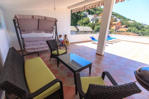 a living room with chairs and a table and a pool at Yu&li Rose Apartments Adriatic in Bar