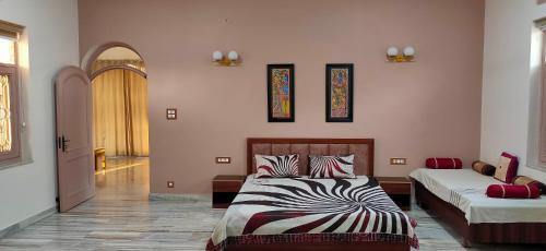 a bedroom with two beds and a hallway at Kosmic Stays in Mathura