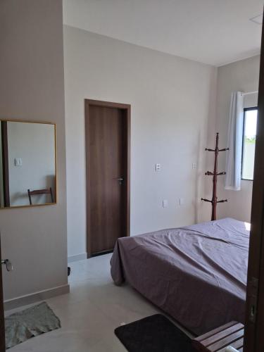 a bedroom with a bed and a mirror at Casa em condomínio porto marina in Ananindeua