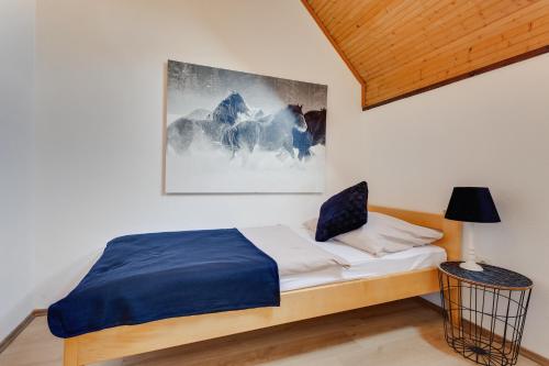 a bedroom with a bed and a painting on the wall at Charly's Apartment in Smoljanac