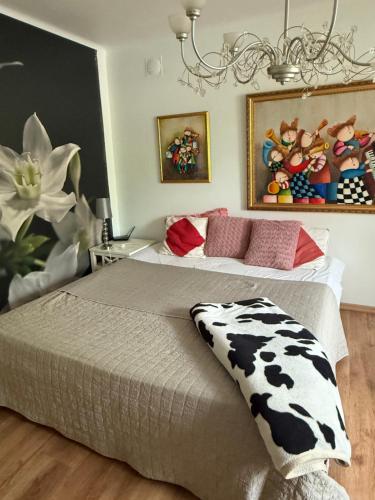 a bedroom with two beds and a chandelier at Anita in Kristianstad