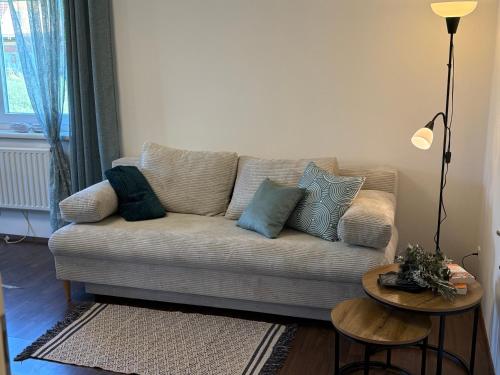 a living room with a couch with pillows on it at WM GEDER Ferienwohnungen Werner in Lebring