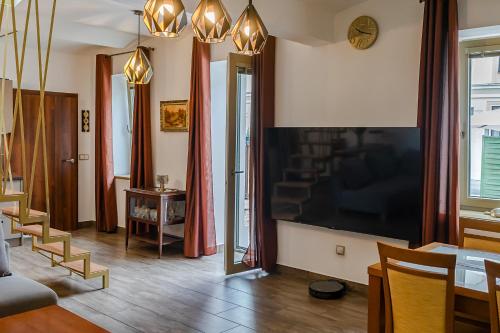a living room with a large flat screen tv on the wall at Penzion Ronox in Česká Skalice