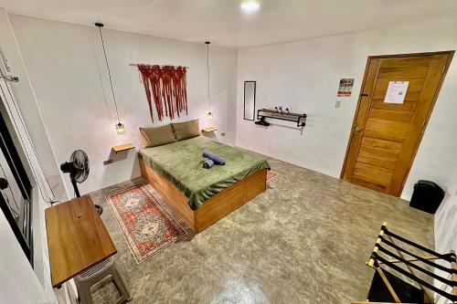 a bedroom with a bed with a stuffed animal on it at Araw Boutique in General Luna