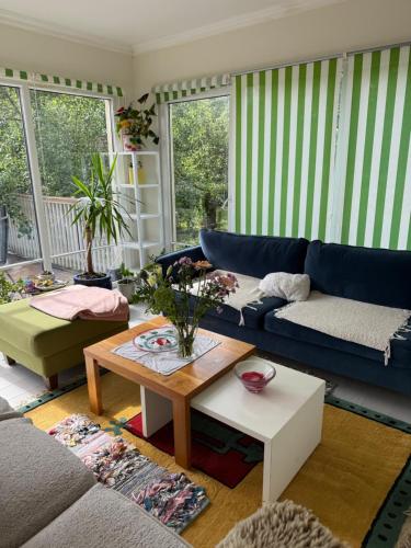a living room with a blue couch and a table at Anita in Kristianstad