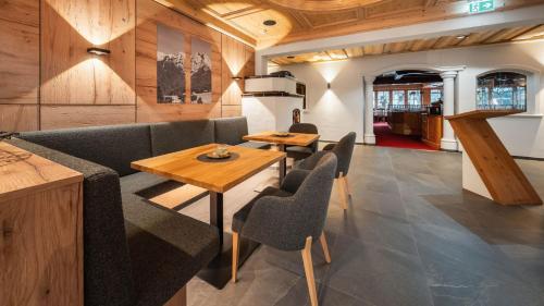 a living room with a couch and a table and chairs at Waidringer Hof 4 Sterne Superior in Waidring