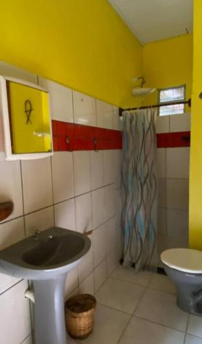 a bathroom with a sink and a toilet at Anjali in Ilha de Boipeba