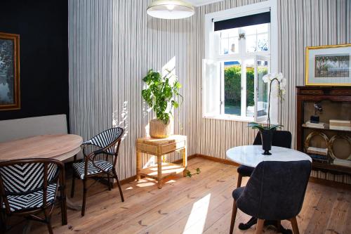 a dining room with a table and chairs and a window at Paarl Hideaway in Paarl