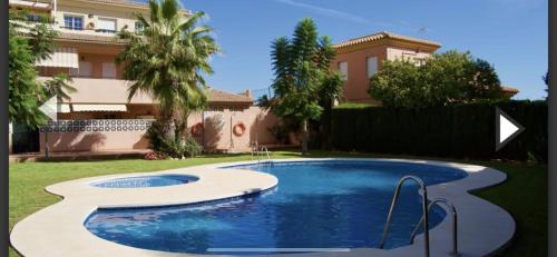 a swimming pool in the yard of a house at Penthouse with fantastic sea view in Arroyo de la Miel