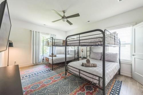 a bedroom with two bunk beds and a ceiling fan at 4BR Queen City Base Minutes to Stadium & NoDa in Charlotte