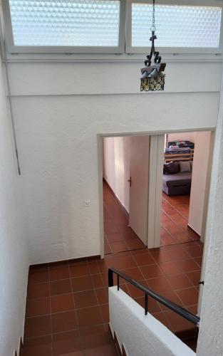 a hallway in a house with a ceiling with a window at ruhiges Haus am See in Agno in Agno